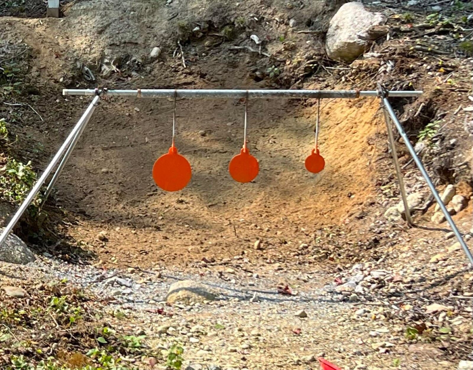 The three orange gongs — 8, 6 and 4 inch — on the rack